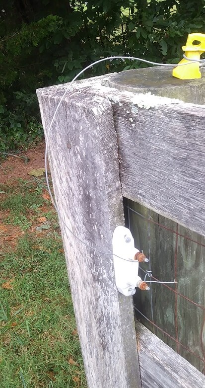 Shows a lightning arrester for an electric fence. One side is connected to the fence wire, one side is connected to a ground.  Once I started using this, I didn't have to fix my electric fence as often after lightning storms.