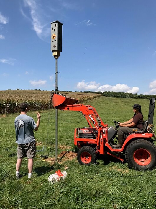 A tractor's front end loader was used to stabilize the bat box in it's vertical position