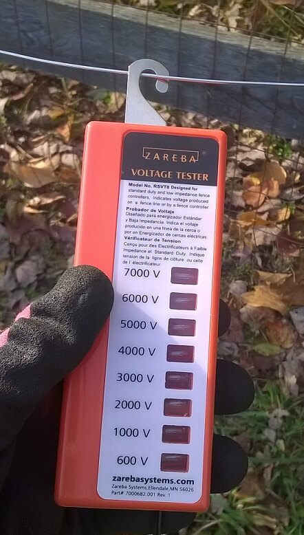 Using a Zareba voltage tester to see if the fence is live.